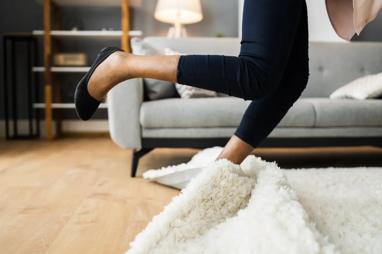 woman tripping over rug
