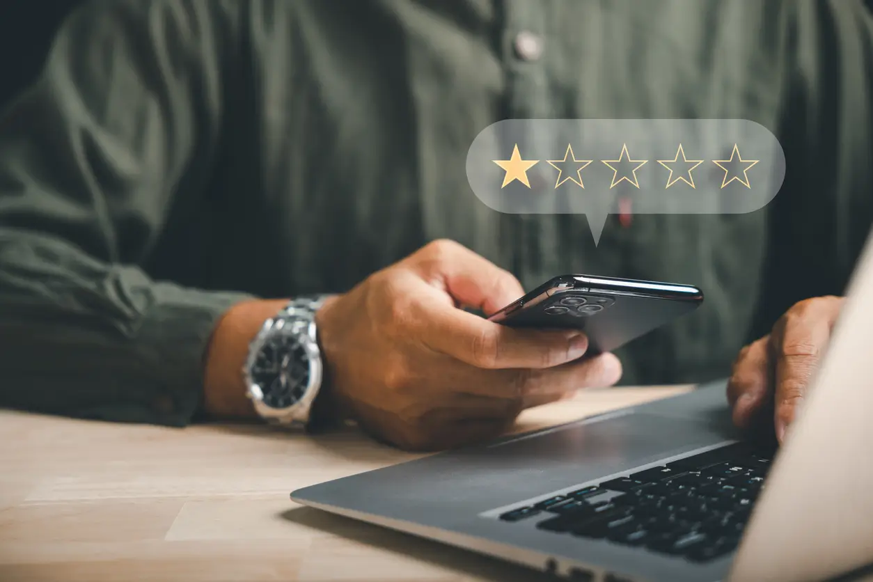 Person checking a negative review on their phone