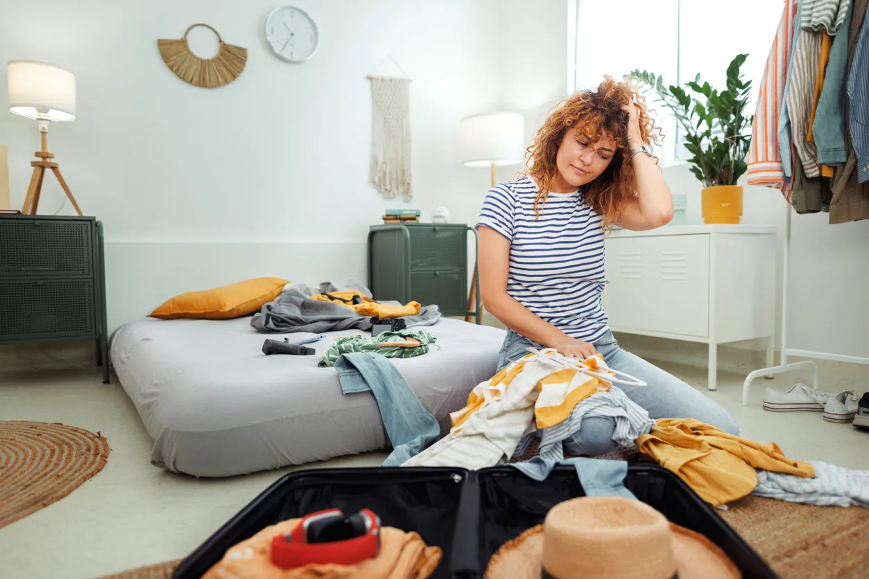 Woman unpacking her suitcase