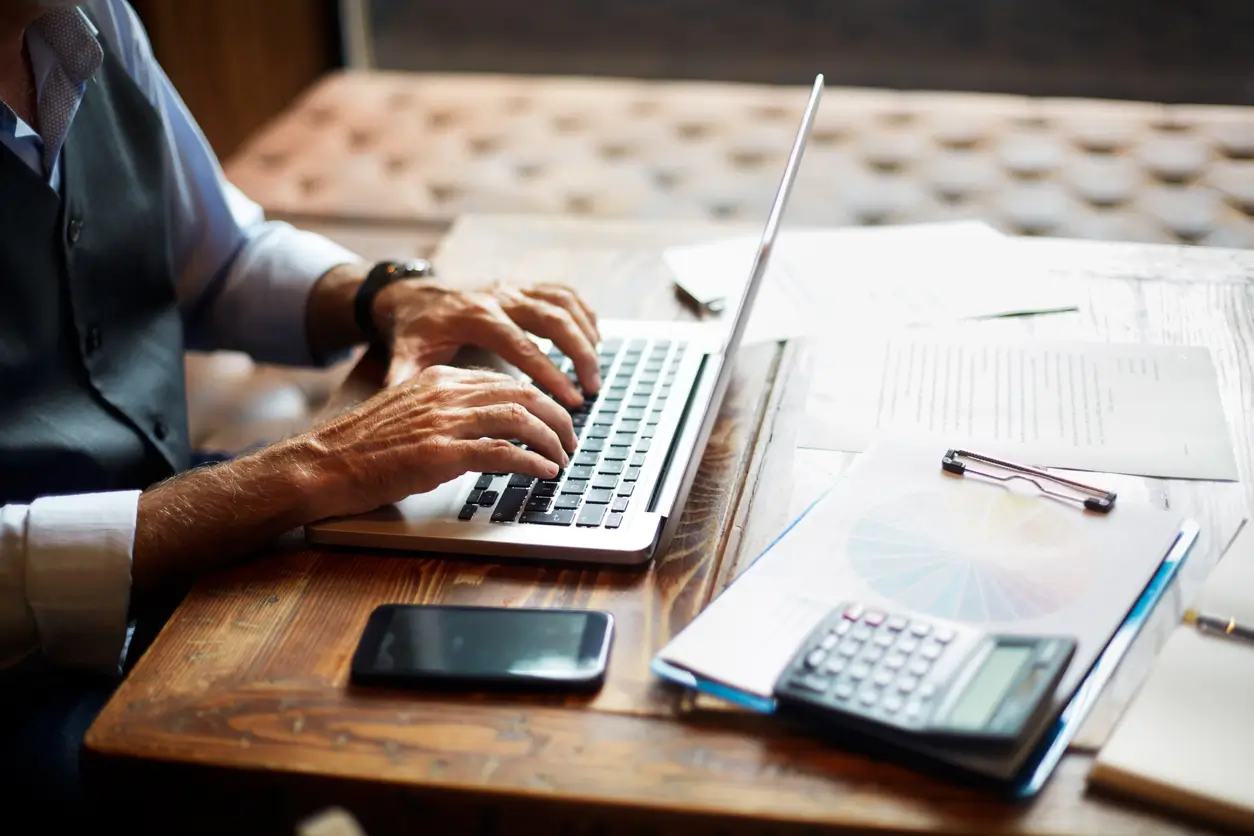 Person working on laptop at desk