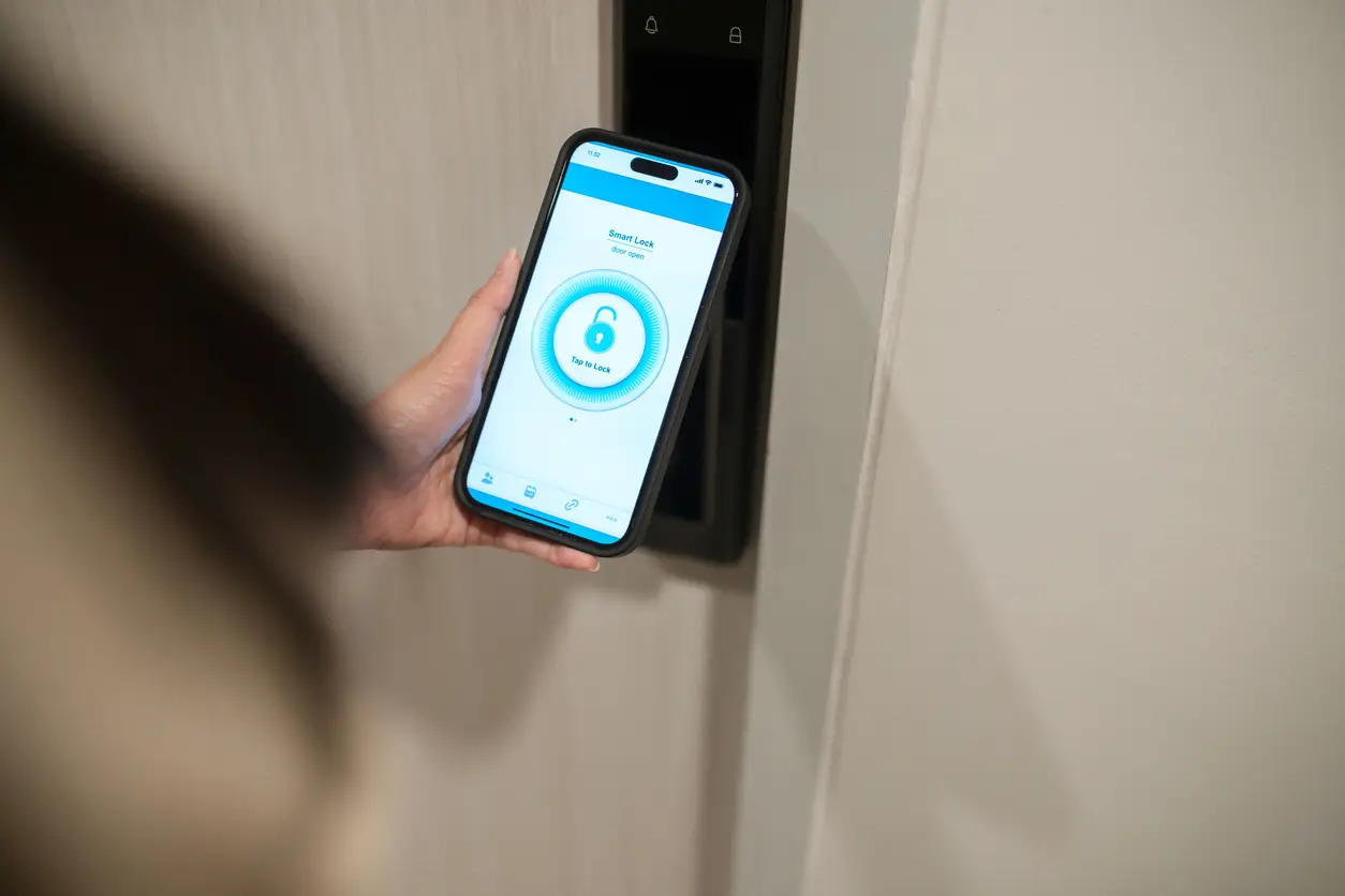 person using a smart phone to unlock door