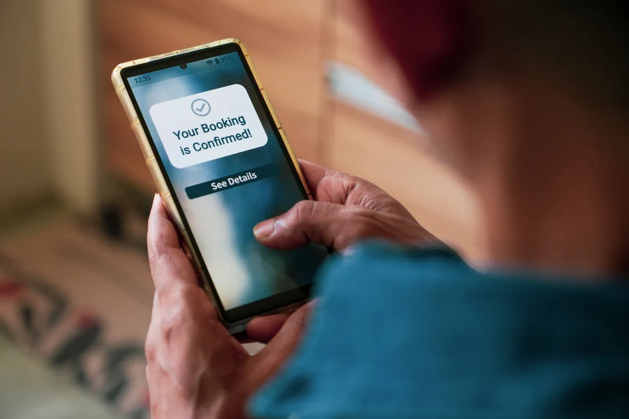 Holidaymaker booking a holiday rental on their phone
