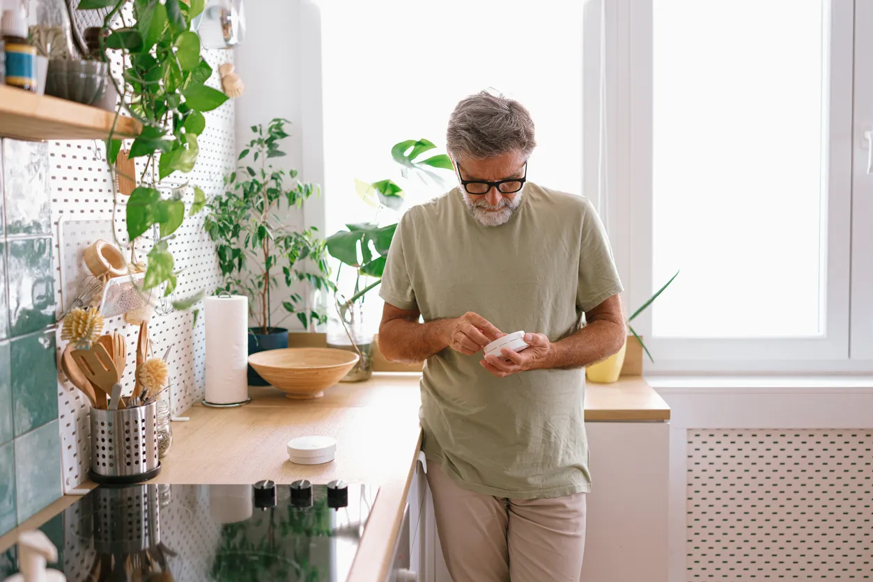 Man checking a smoke alarm is working
